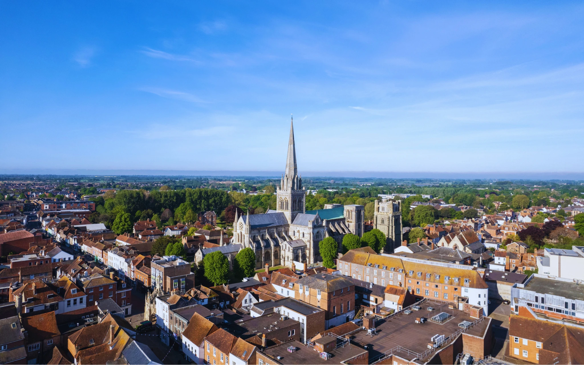 Aerial view of Chichester with the historic cathedral spire rising above the city centre and surrounding rooftops