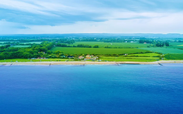 Scenic aerial view of Littlehampton beach and coastline with green fields and countryside stretching inland