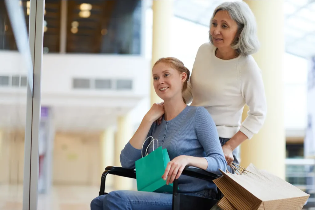A professional carer from our consistent team assists an elderly client with choosing items during a grocery shopping trip in West Sussex.