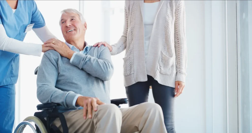 A professional Careline 24 carer provides careful medication support to an elderly client in his Bognor Regis home, ensuring safety and wellbeing.