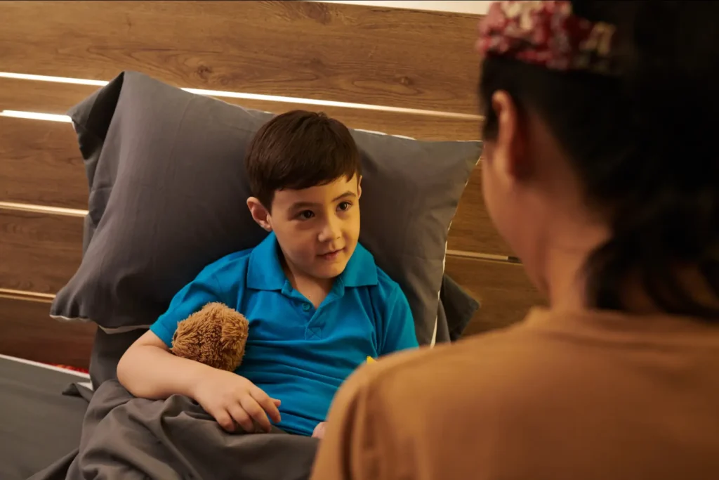 A compassionate Careline 24 carer providing reassuring support to a preteen boy with a learning disability, offering comfort and security in his own home.