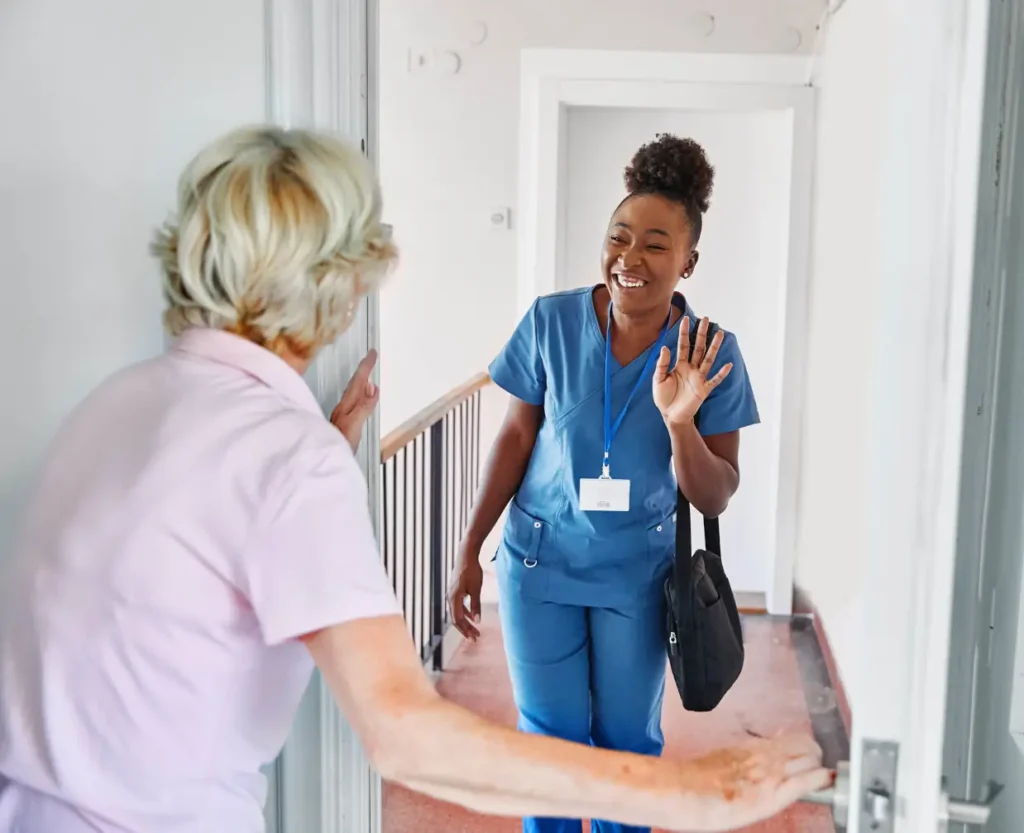  A professional carer from a small, consistent team supports an active elderly lady with gardening during a home care visit in West Sussex.
