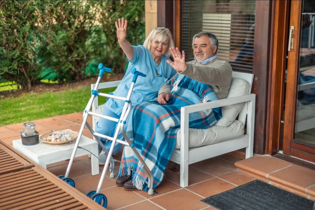 A small group of older adults with dementia and their compassionate carer from Careline 24 enjoy a engaging and social activity together in a bright, comfortable room in West Sussex.