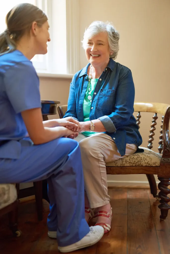  An elderly lady shares a warm, grateful smile with her dedicated Careline 24 carer, reflecting a trusting and supportive relationship built on consistent care.
