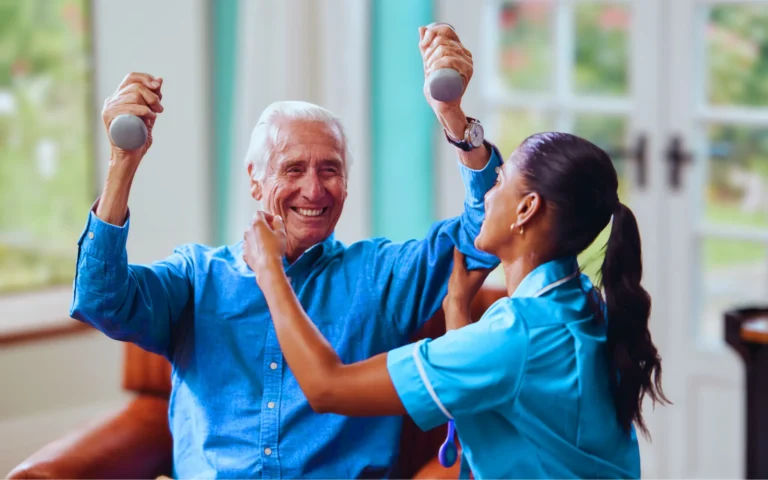 elderly man smiles while lifting small hand weights