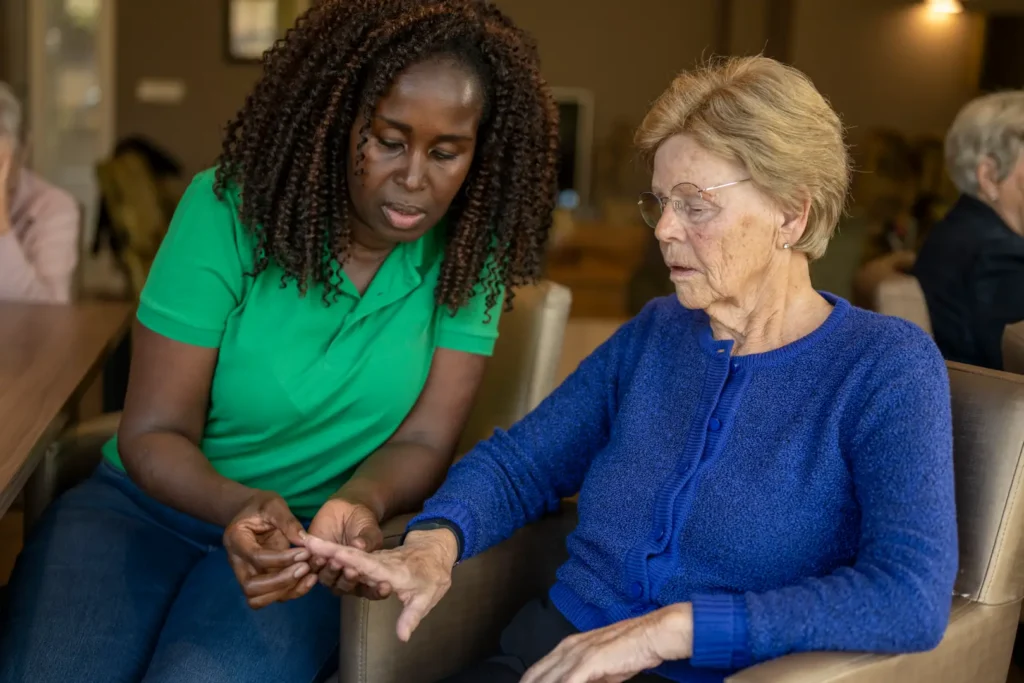 A compassionate, professional female carer from our small consistent team assists an elderly lady with personal care at her home in West Sussex, ensuring her dignity and independence.