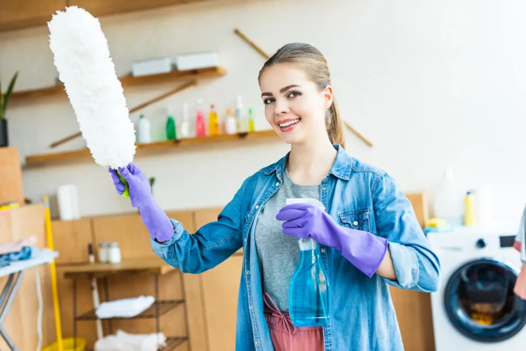 A professional carer from our consistent team provides light housekeeping support by cleaning kitchen surfaces in a client's home.