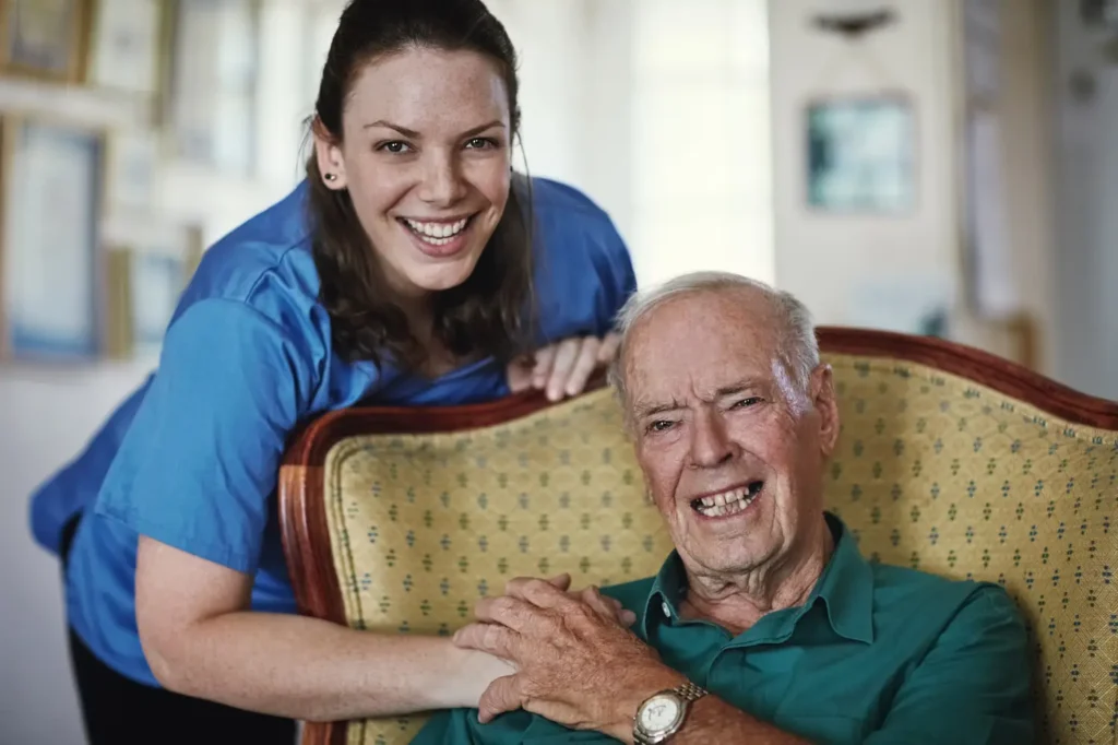 A Careline 24 carer prepares a nutritious meal for an elderly client in their Bognor Regis kitchen, providing supportive mealtime assistance with a smile.